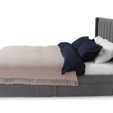 Comfortable gray bed with linens on white background