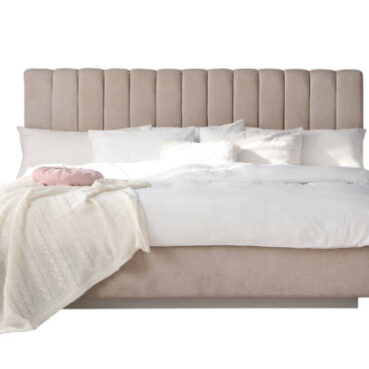 Elegant cozy bed with headboard, blanket and pillows on white background