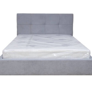 Double bed with soft headboard. Cushioned furniture.