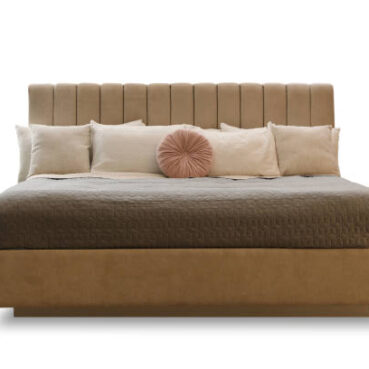Elegant cozy bed with headboard, blanket and pillows on white background